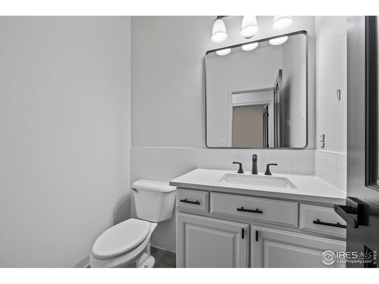 2097 Meander Road Windsor, CO 80550 - Photo 21 of 33 a bathroom with a toilet sink and mirror