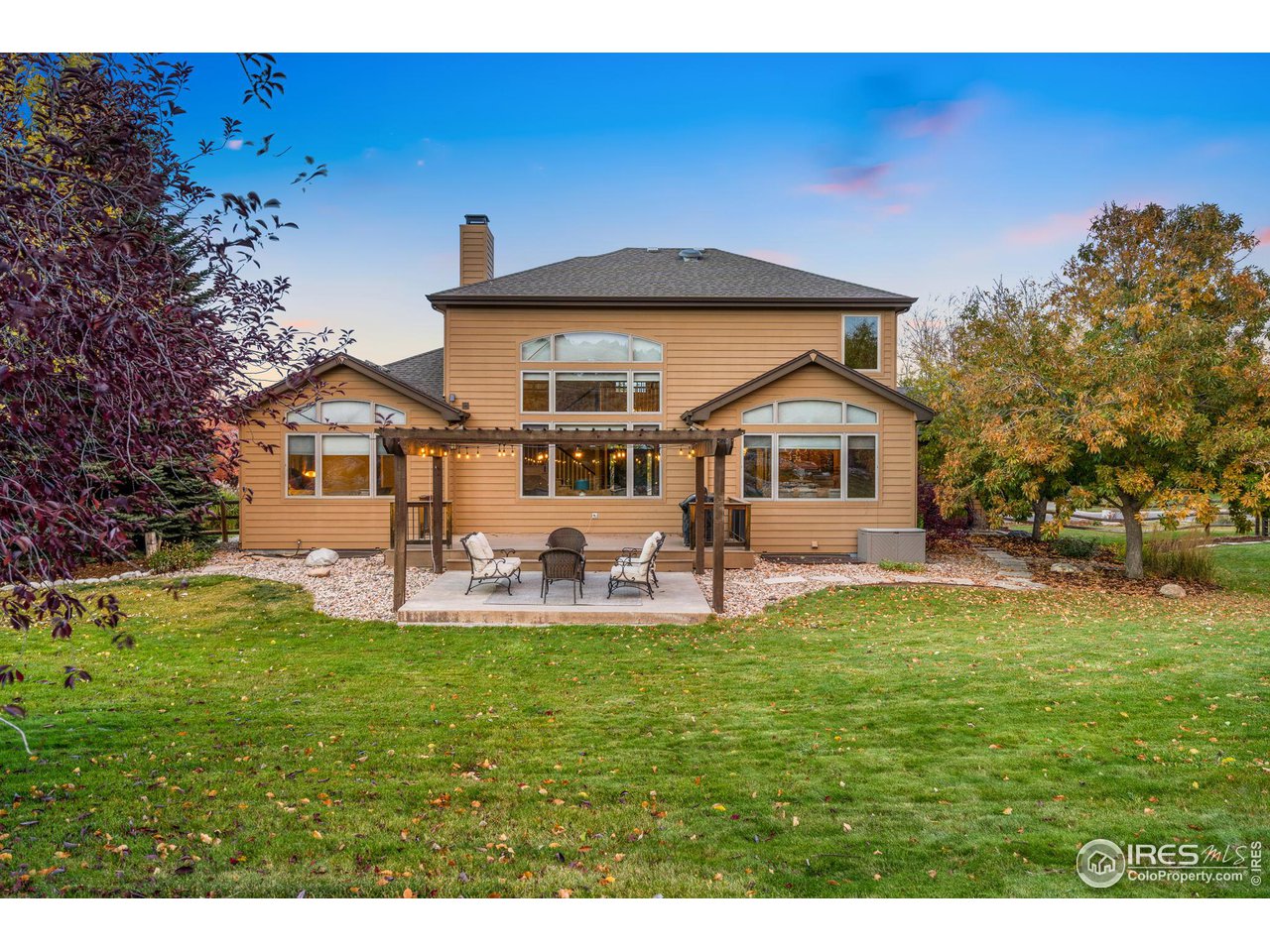 2097 Meander Road Windsor, CO 80550 - Photo 26 of 33 a front view of a house with a yard porch and outdoor seating