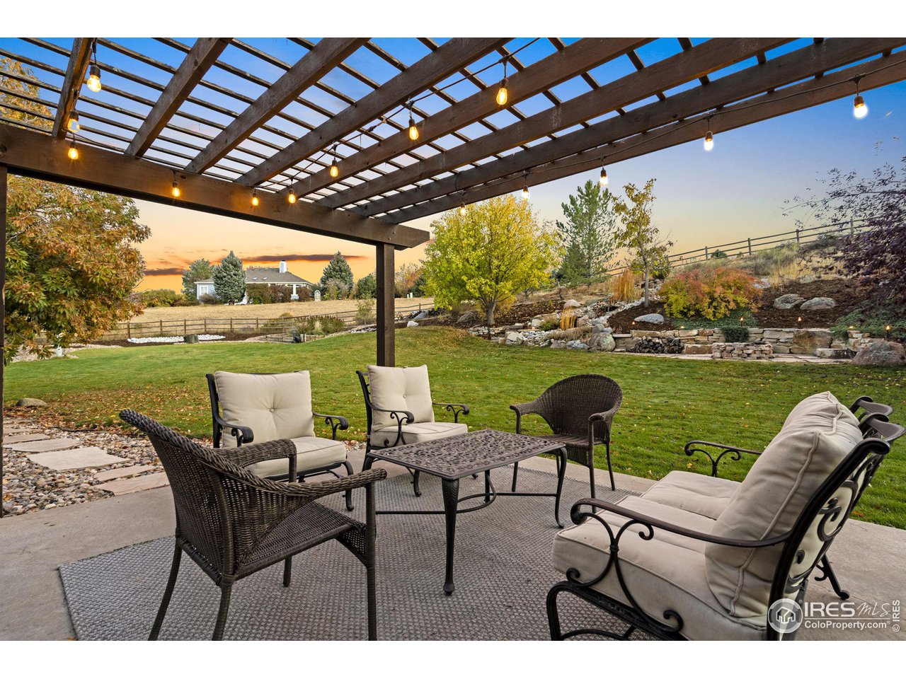 2097 Meander Road Windsor, CO 80550 - Photo 28 of 33 a view of a chairs and table in the patio next to a yard