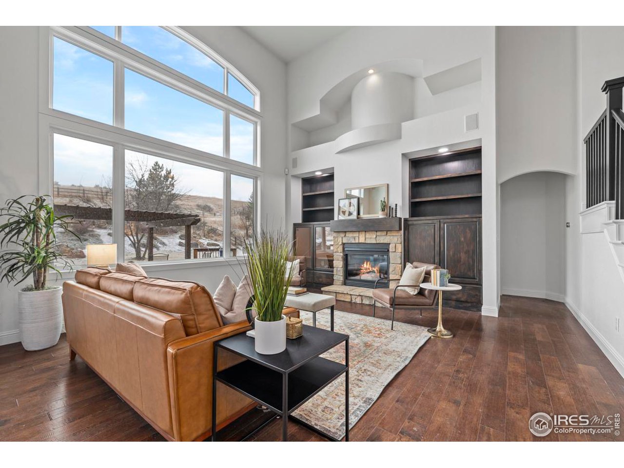 2097 Meander Road Windsor, CO 80550 - Photo 3 of 33 a living room with fireplace furniture and a large window