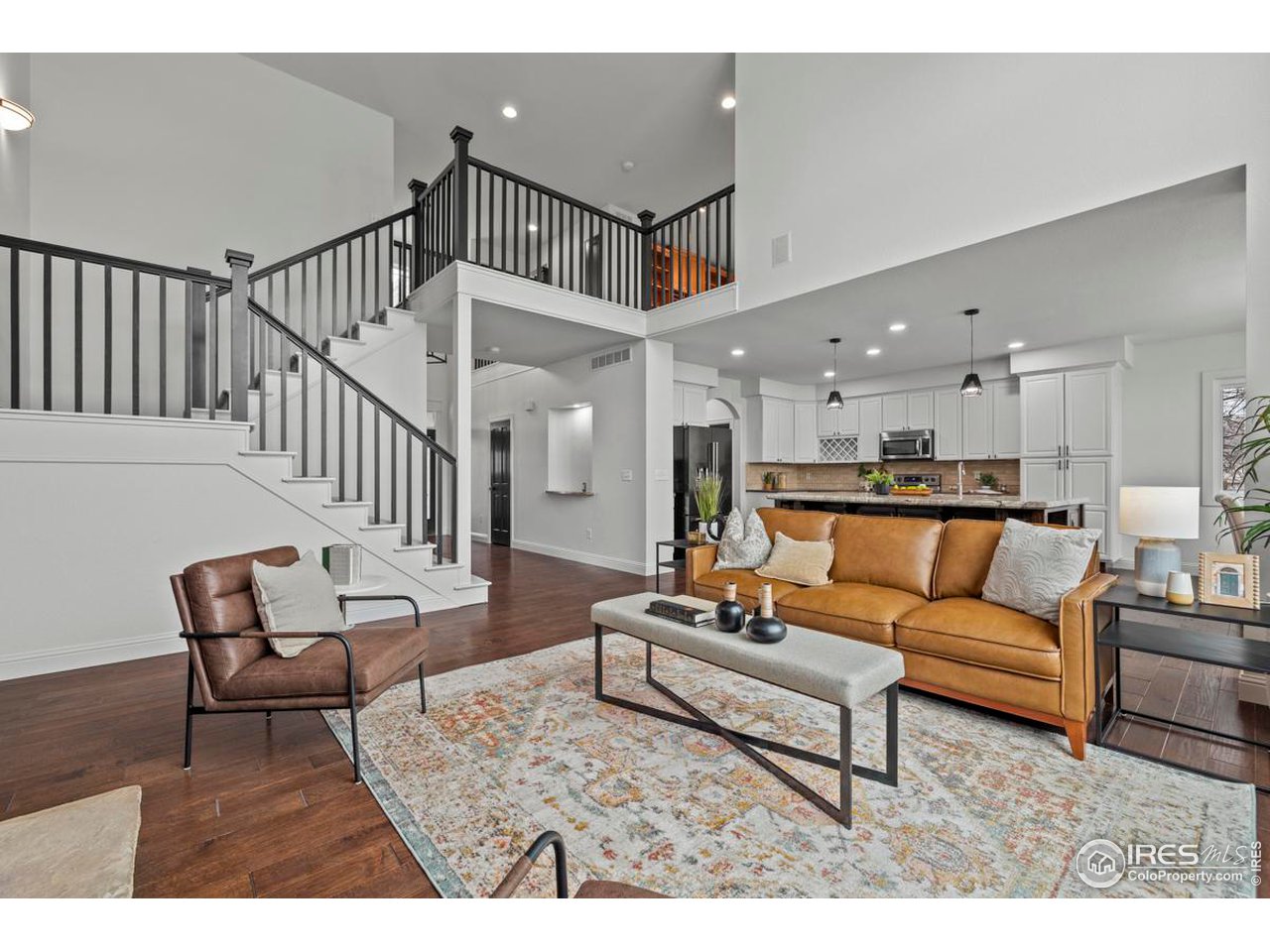 2097 Meander Road Windsor, CO 80550 - Photo 5 of 33 a living room with furniture and wooden floor