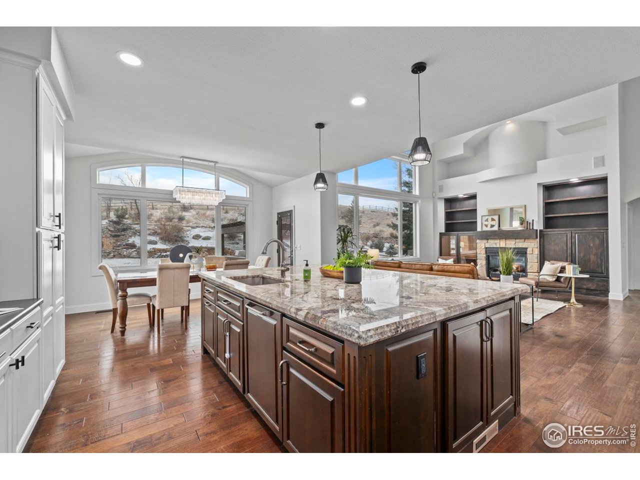 2097 Meander Road Windsor, CO 80550 - Photo 8 of 33 a kitchen with stainless steel appliances granite countertop wooden cabinets a stove a sink and a large window