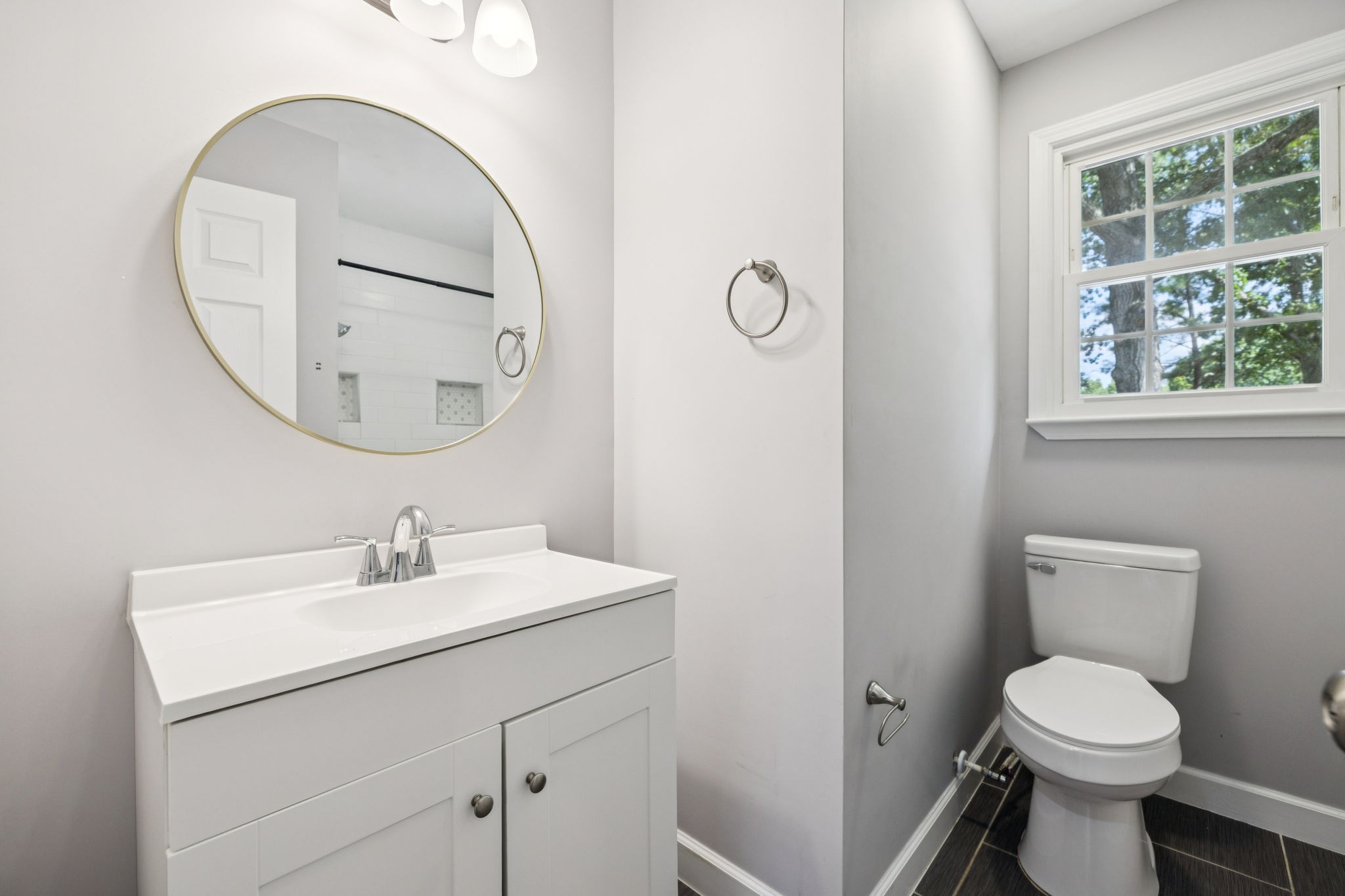 102 Warren Place Dickson, TN 37055 - Photo 17 of 52 a bathroom with a toilet a sink a mirror and a window