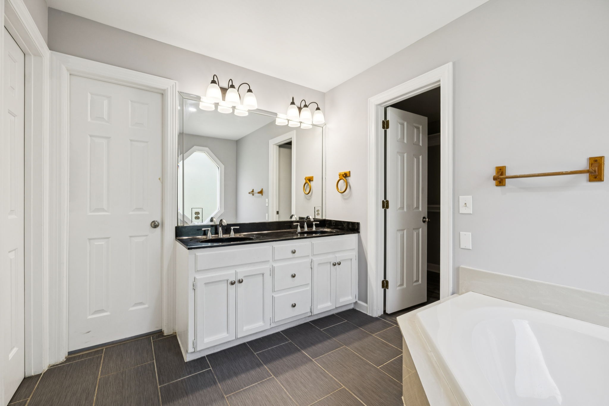 102 Warren Place Dickson, TN 37055 - Photo 26 of 52 a spacious bathroom with a granite countertop sink and a mirror
