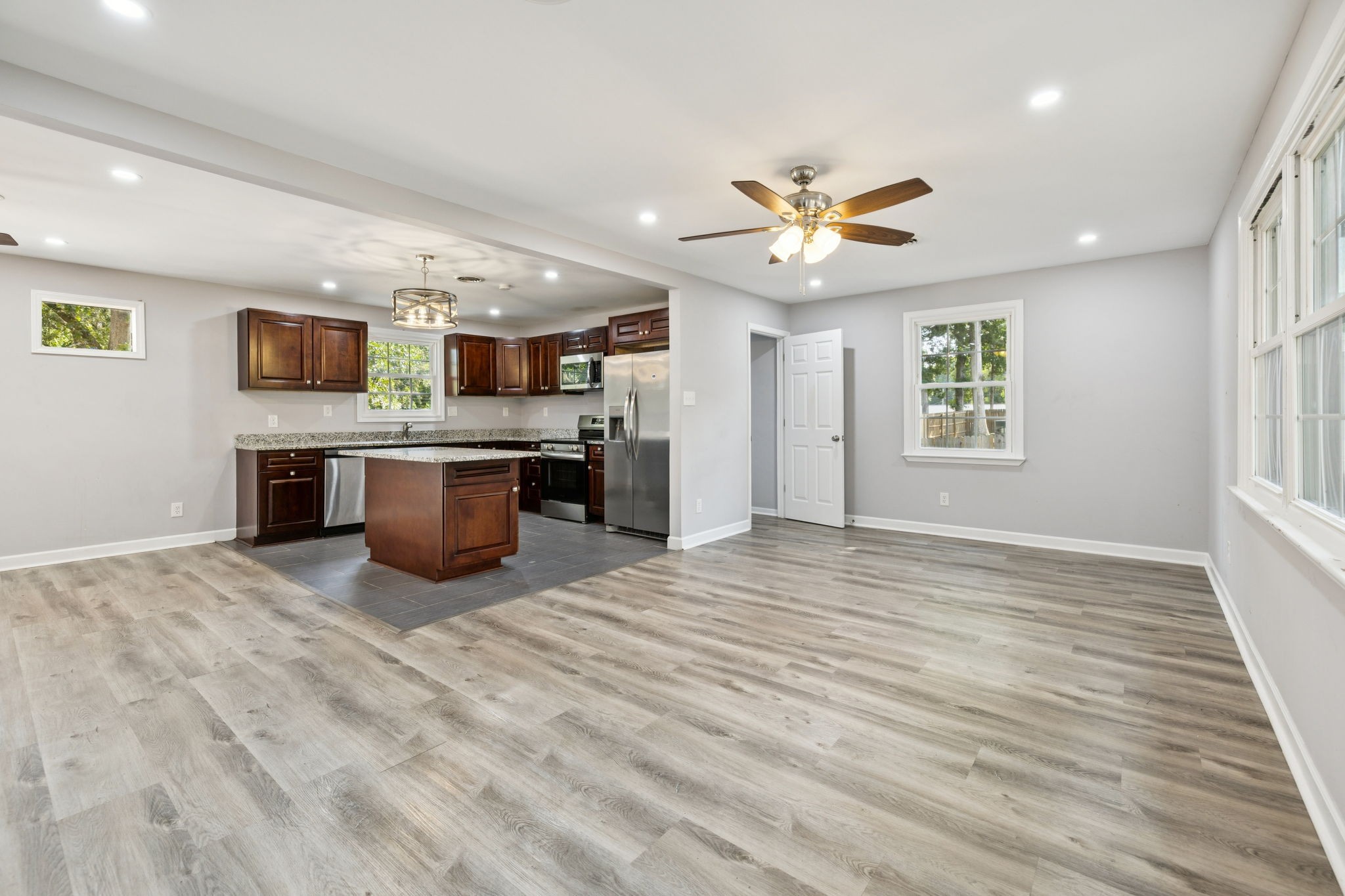 102 Warren Place Dickson, TN 37055 - Photo 3 of 52 a view of kitchen and kitchen with furniture wooden floor and window