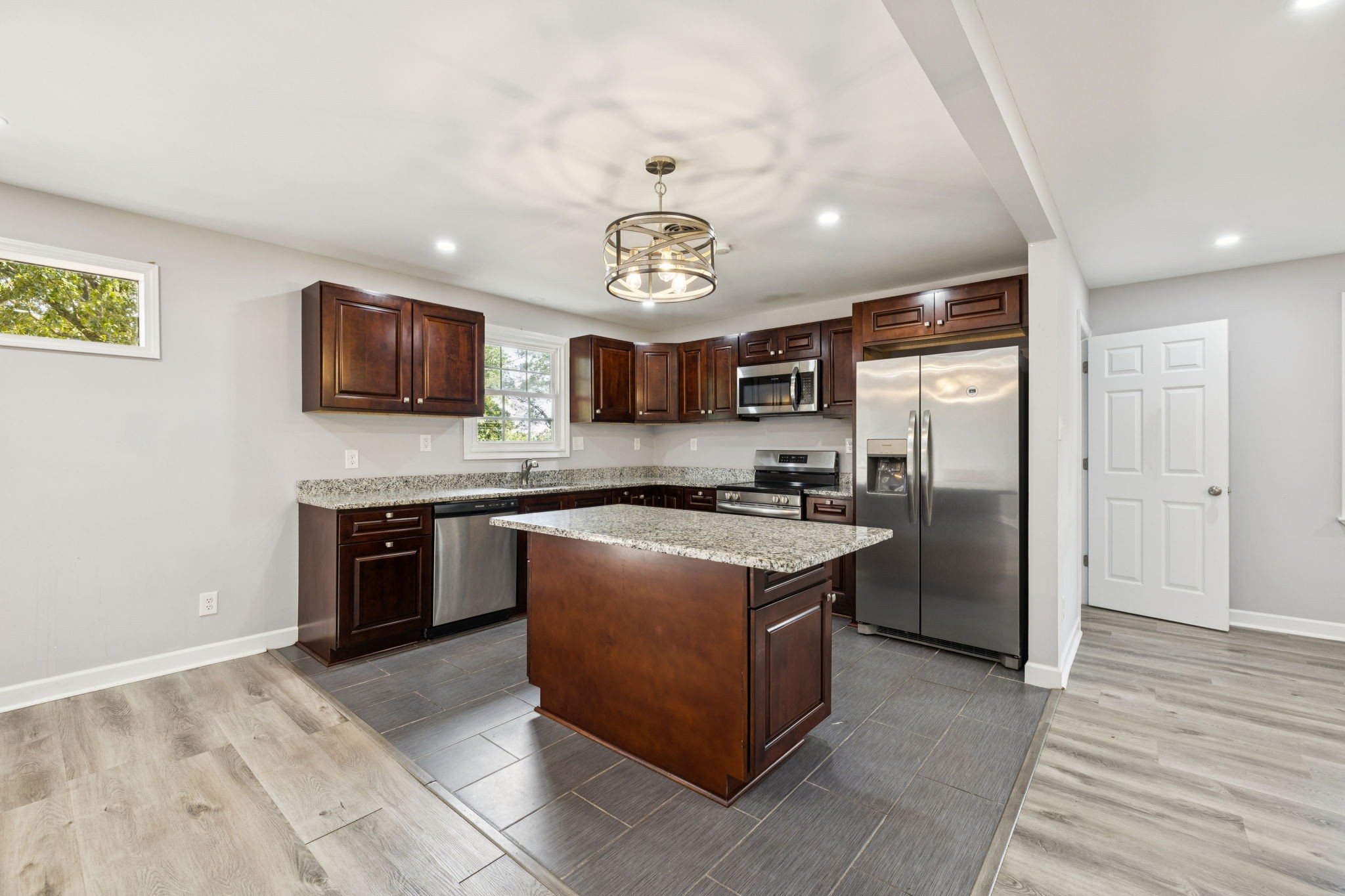 102 Warren Place Dickson, TN 37055 - Photo 7 of 52 a kitchen with stainless steel appliances granite countertop a stove refrigerator sink and microwave