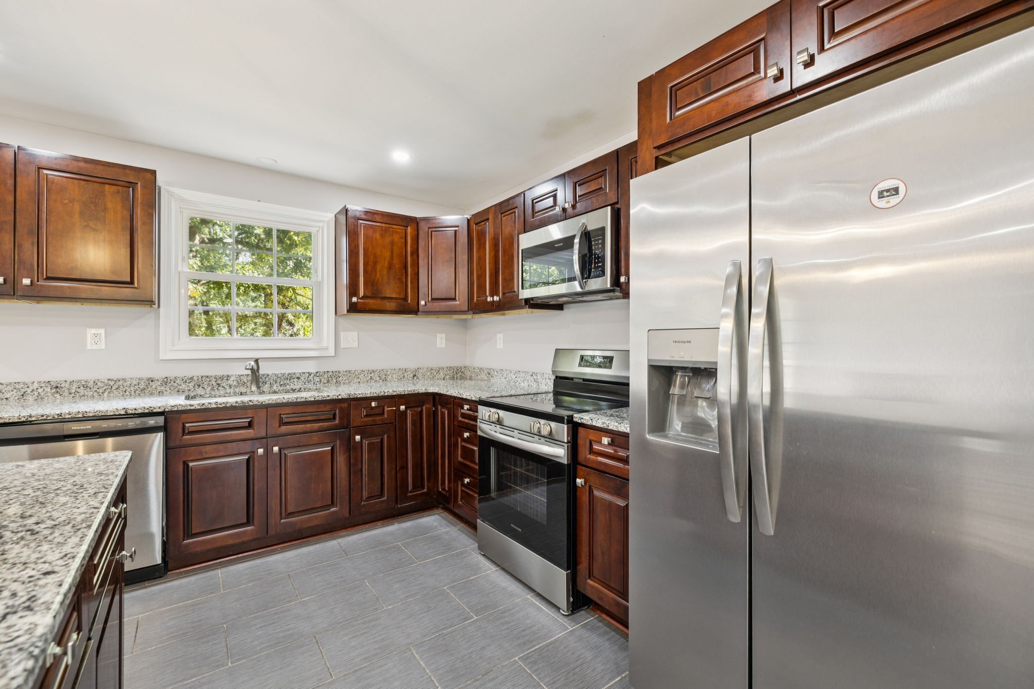 102 Warren Place Dickson, TN 37055 - Photo 9 of 52 a kitchen with stainless steel appliances granite countertop a refrigerator and a sink