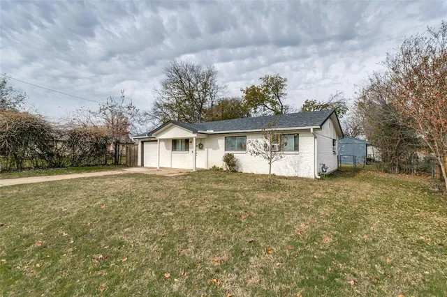 a house with green field in front of it