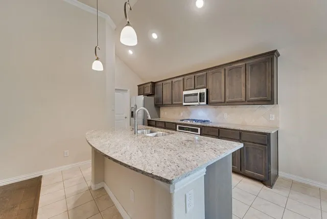 a kitchen with stainless steel appliances granite countertop a sink and granite counter tops