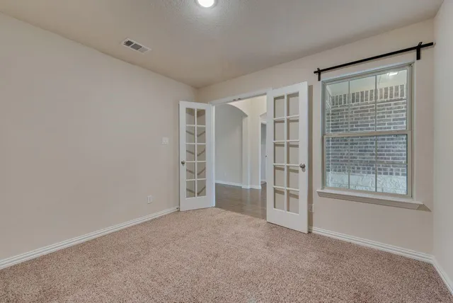 an empty room with windows and closet