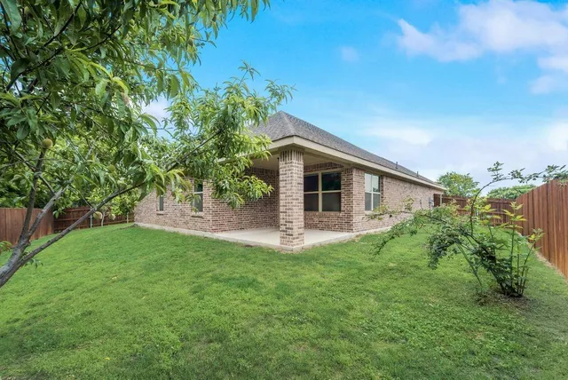 a backyard of a house with lots of green space