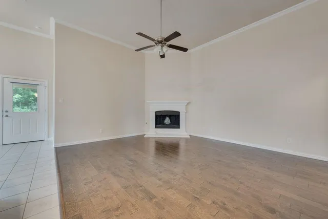 a view of a livingroom with a ceiling fan and hardwood floor