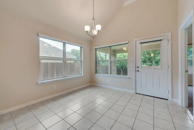 a view of an empty room with windows