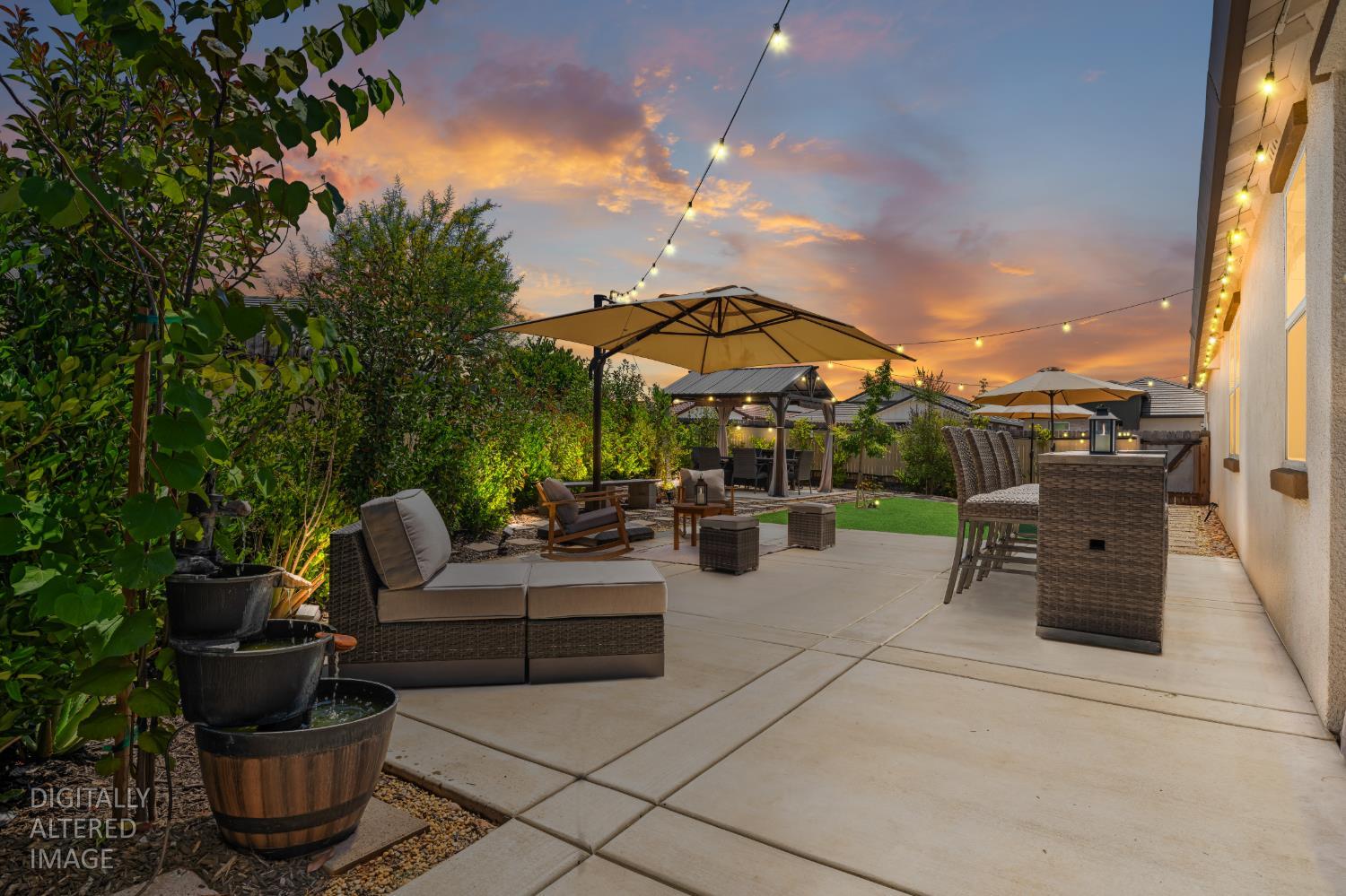 4216 Creede Way Rancho Cordova, CA 95742 - Photo 40 of 56 a view of a patio with couches and chairs under an umbrella with a fire pit