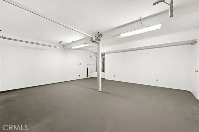 a spacious bathroom with a granite countertop sink and a mirror