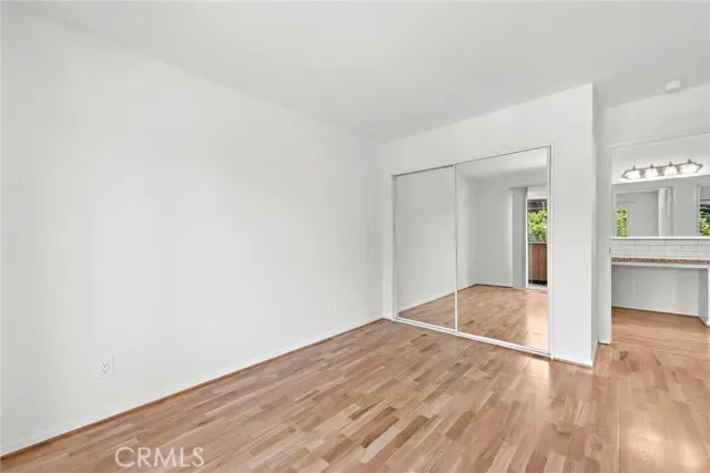a view of a livingroom with a fireplace a ceiling fan and windows