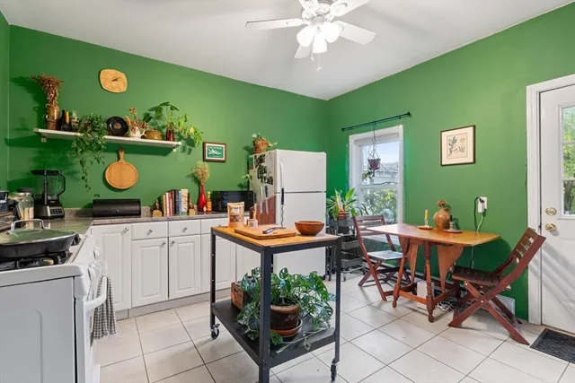 a view of a kitchen with kitchen island and stainless steel appliances