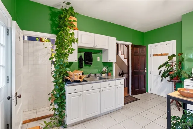 a kitchen with a refrigerator and a sink