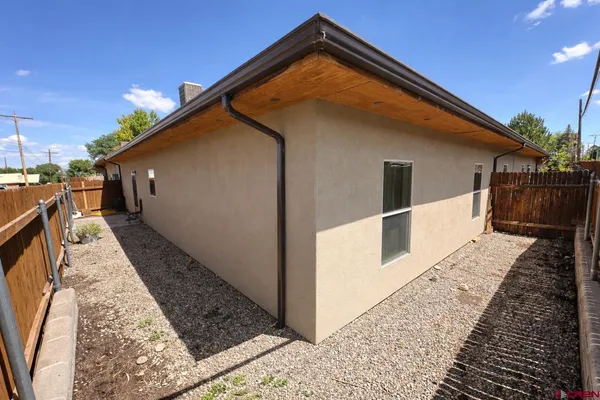 a view of house with wooden floor and wooden fence