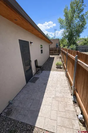 a view of a balcony with wooden floor and fence