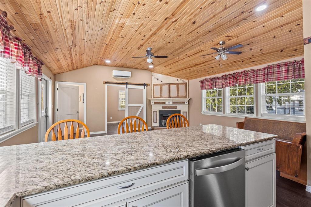 105 Reich Street Bonham, TX 75418 - Photo 12 of 31 a kitchen with stainless steel appliances granite countertop a sink window and cabinets