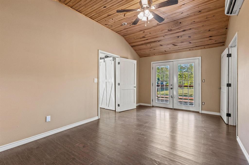 105 Reich Street Bonham, TX 75418 - Photo 15 of 31 a view of an empty room with wooden floor and a window