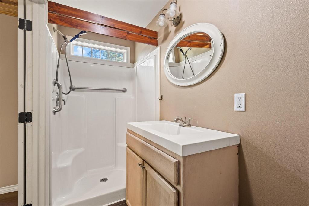 105 Reich Street Bonham, TX 75418 - Photo 18 of 31 a bathroom with a sink and a mirror