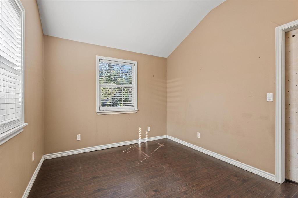 105 Reich Street Bonham, TX 75418 - Photo 21 of 31 an empty room with wooden floor and windows