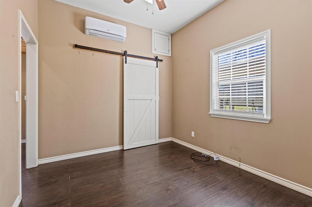 105 Reich Street Bonham, TX 75418 - Photo 23 of 31 a view of an empty room with wooden floor and a window