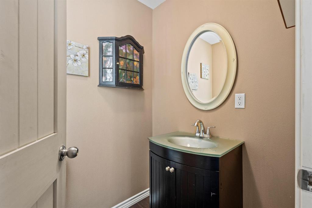 105 Reich Street Bonham, TX 75418 - Photo 24 of 31 a bathroom with a sink and a mirror