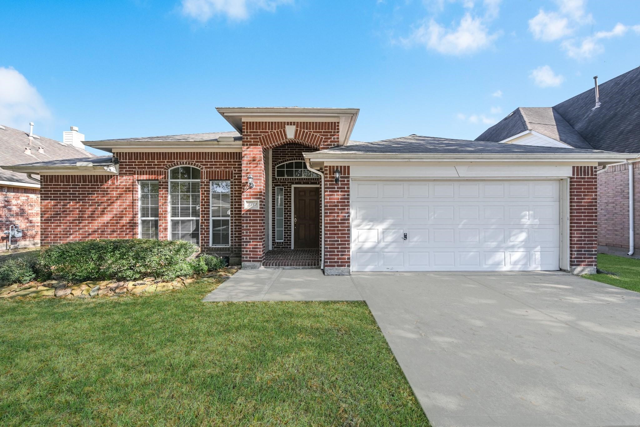 a front view of a house with a yard and garage