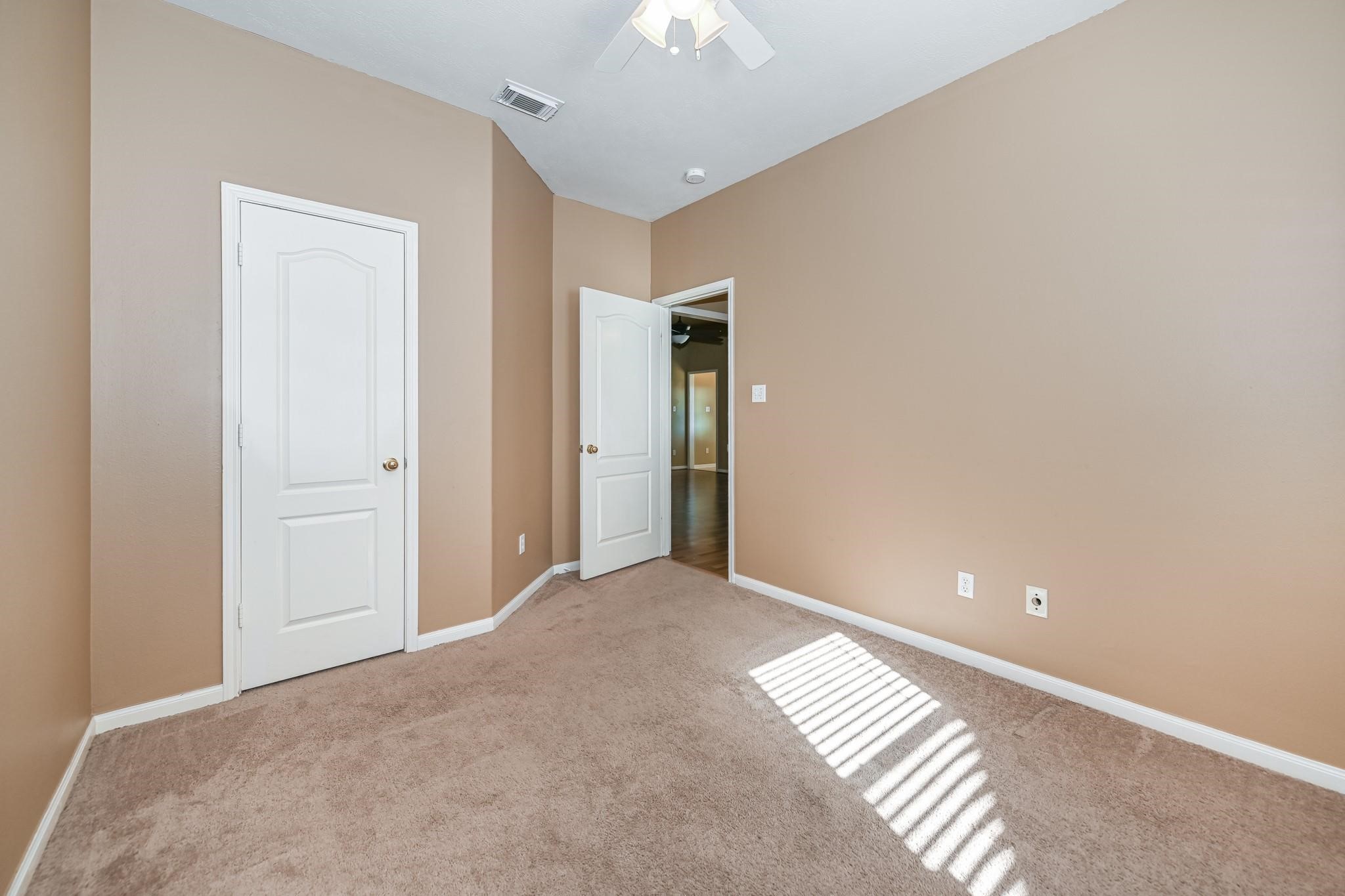 10002 Forest Spring Lane Pearland, TX 77584 - Photo 14 of 18 a view of an empty room and chandelier fan