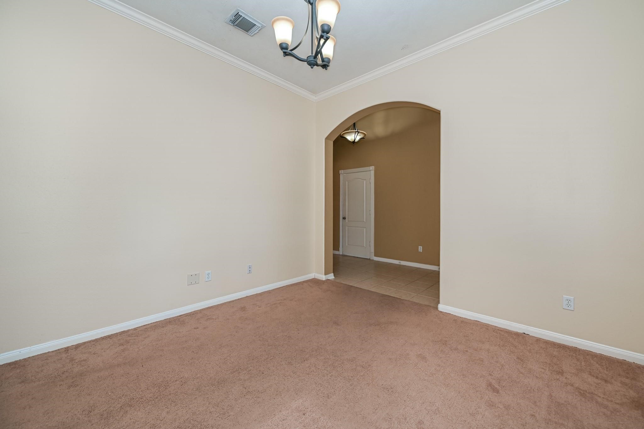 10002 Forest Spring Lane Pearland, TX 77584 - Photo 16 of 18 an empty room that has a chandelier fan