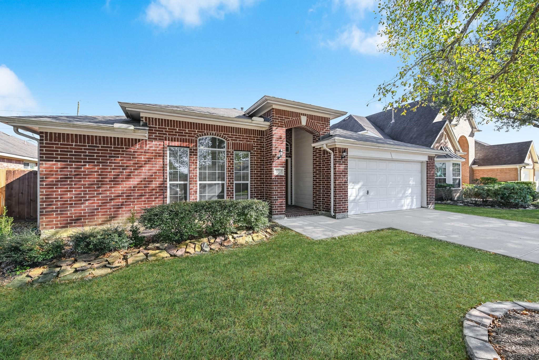 10002 Forest Spring Lane Pearland, TX 77584 - Photo 2 of 18 a front view of a house with a garden