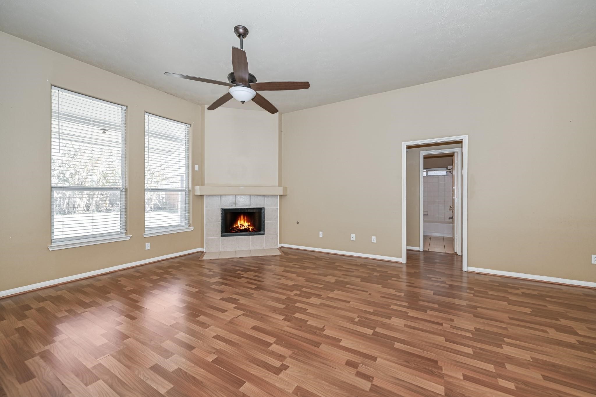 10002 Forest Spring Lane Pearland, TX 77584 - Photo 3 of 18 a view of empty room with wooden floor and fan