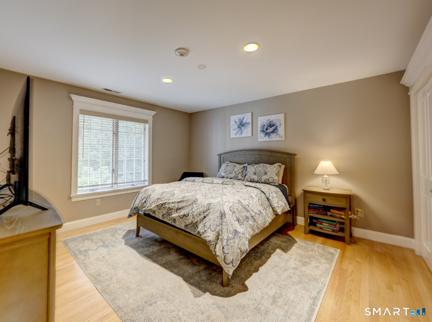 13 Executive Hill Road Wolcott, CT 06716 - Photo 28 of 40 a bedroom with a bed and a flat tv screen on dresser