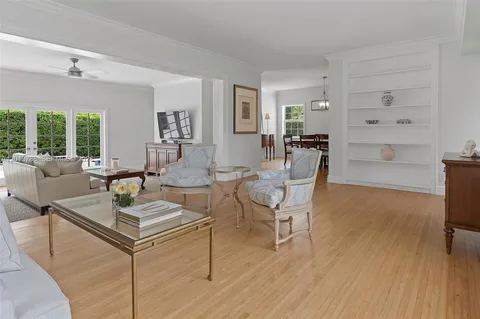 a living room with fireplace furniture and a table