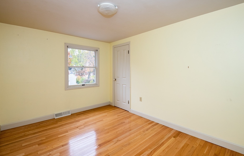 6 Island Park Road Ipswich, MA 01938 - Photo 26 of 41 an empty room with wooden floor and windows