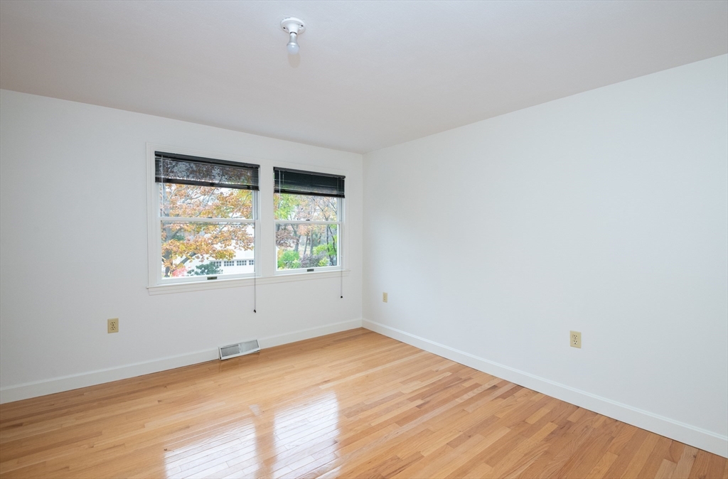 6 Island Park Road Ipswich, MA 01938 - Photo 27 of 41 an empty room with wooden floor and windows