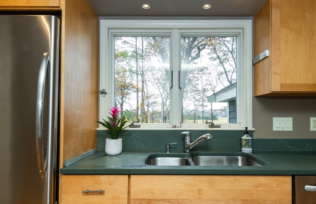 6 Island Park Road Ipswich, MA 01938 - Photo 9 of 41 a counter with granite countertop a potted plant on a granite counter top