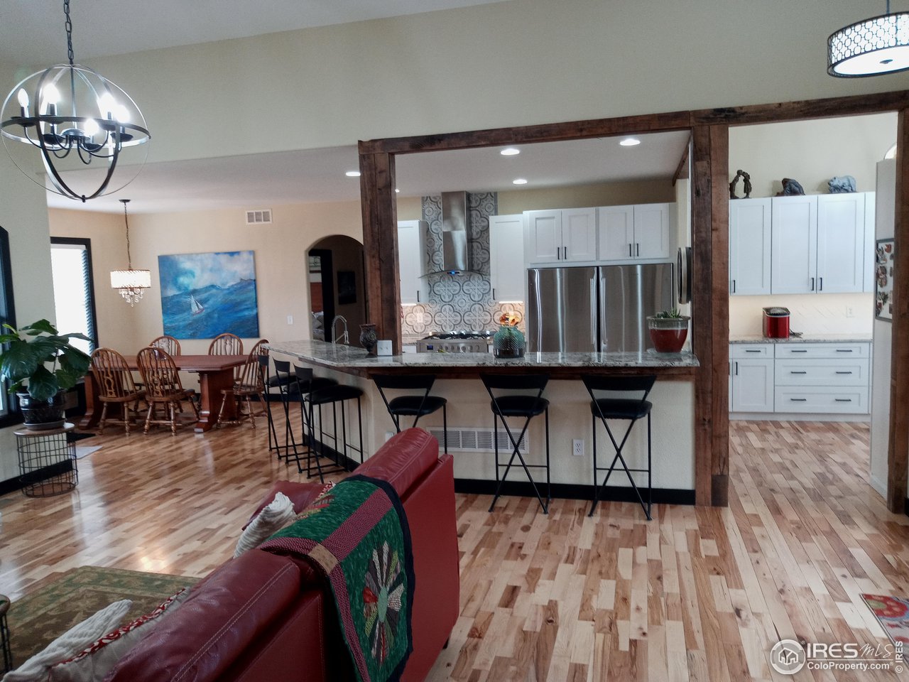 1408 Red Fox Circle Severance, CO 80550 - Photo 6 of 24 a living room with furniture and kitchen view