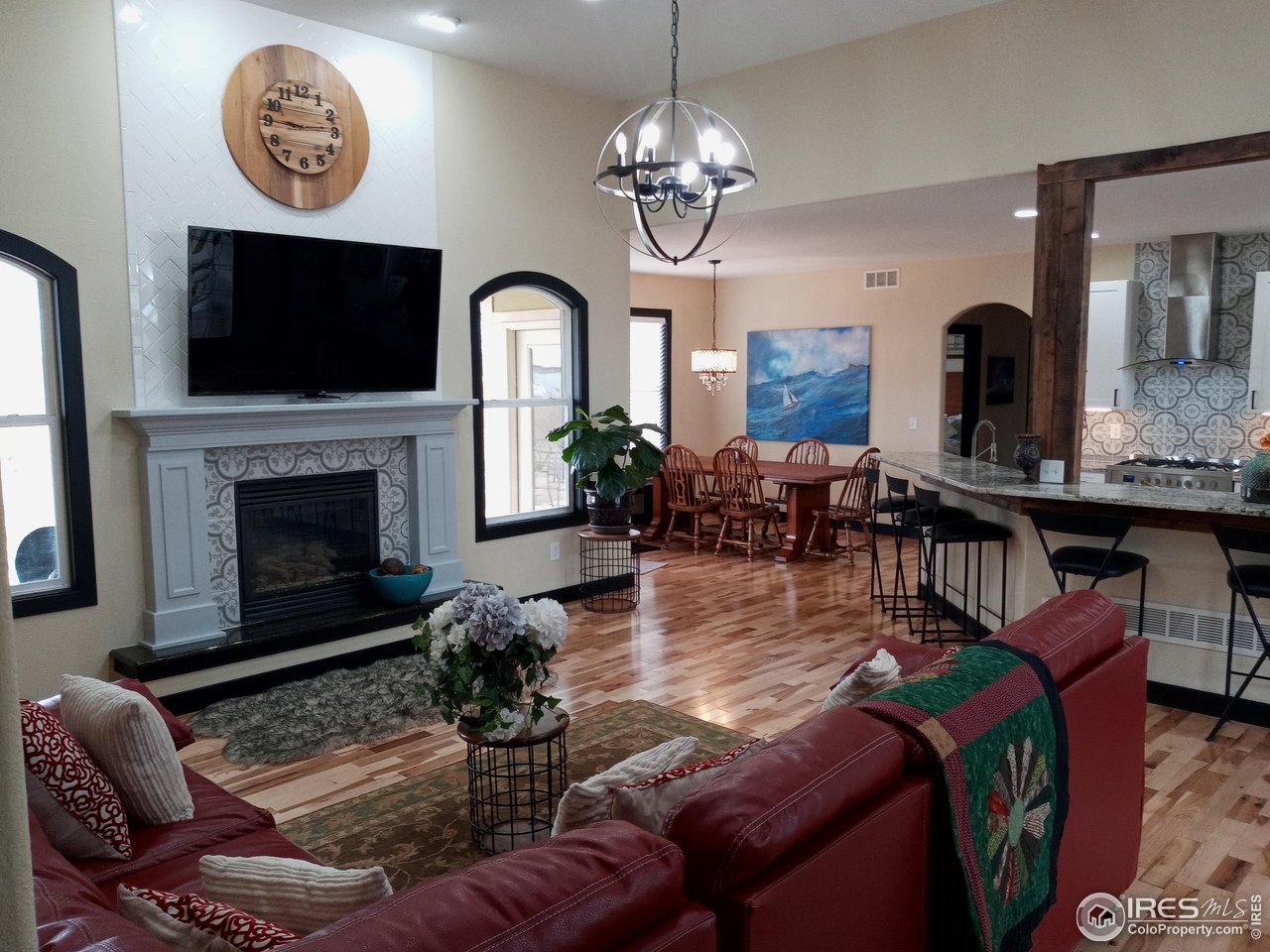 1408 Red Fox Circle Severance, CO 80550 - Photo 8 of 24 a living room with furniture a flat screen tv and a fireplace
