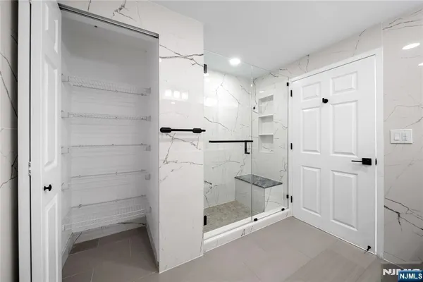 a bathroom with a glass shower door