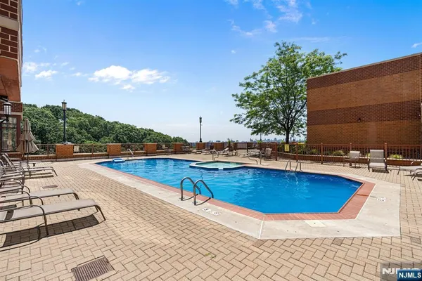 a view of a swimming pool with lounge chair