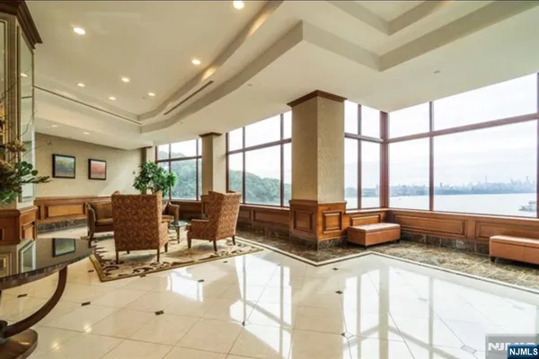 a dining room with furniture a large window and a chandelier