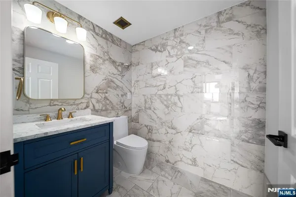 a bathroom with a sink toilet and mirror