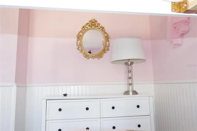 a bedroom with bed and wooden floor