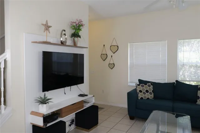 a living room with furniture and a flat screen tv