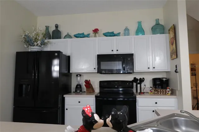 a kitchen with a refrigerator and a stove