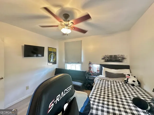 a bedroom with furniture and a flat screen tv